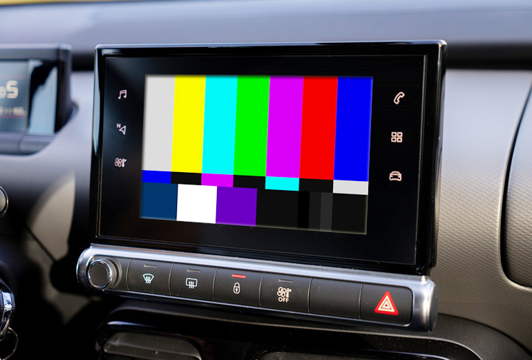 grafika przedstawia ekran cyfrowy w samochodzie z wyświetlonym obrazem kontrolnym